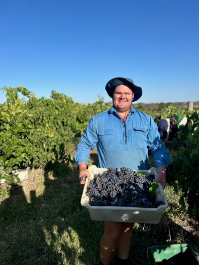 a man that is standing in the grass